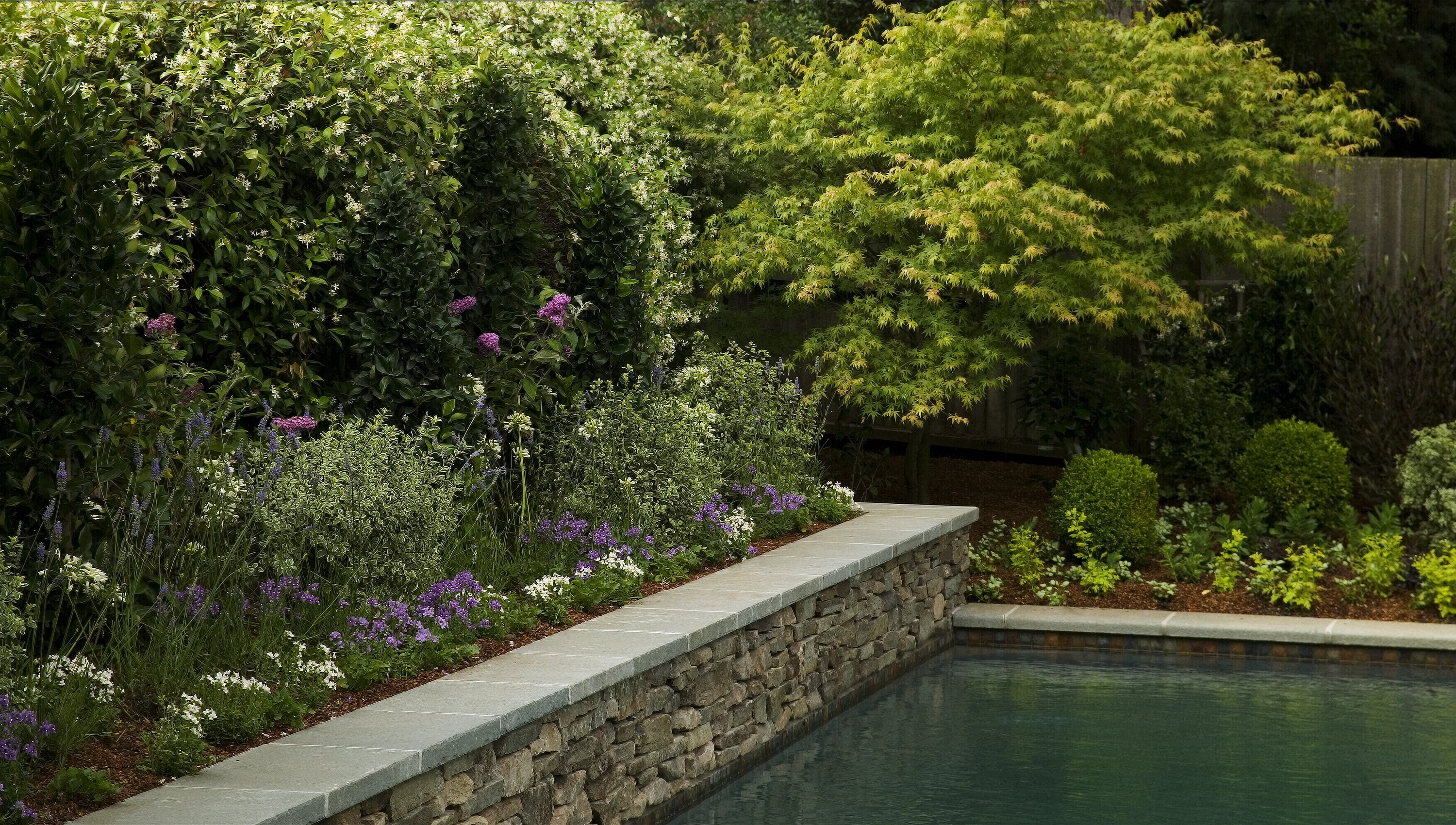 Limestone pool with stone wall close up